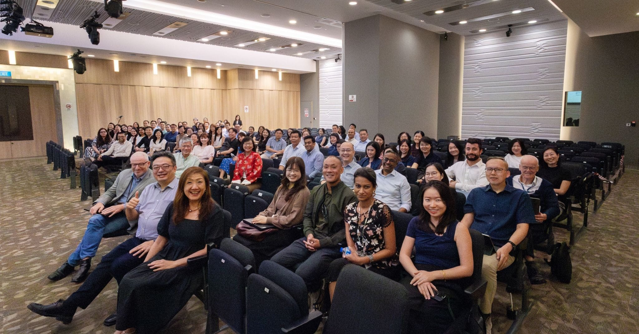 A large group of people in a seminar.